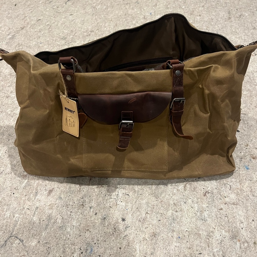 Newhey tan and brown canvas bag with faux leather trim. Extremely stylish.